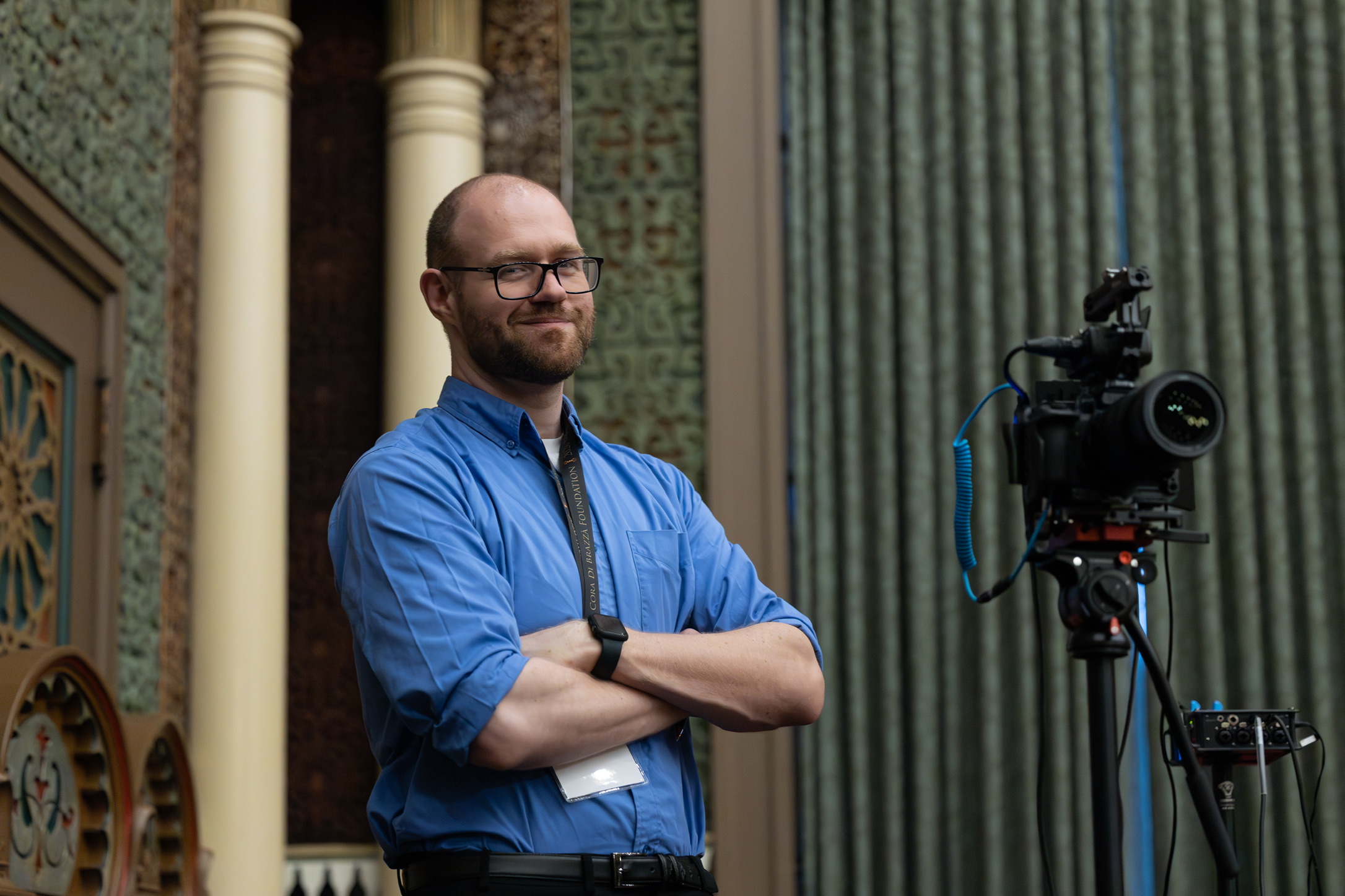 Randall Olson beside a camera at a community program